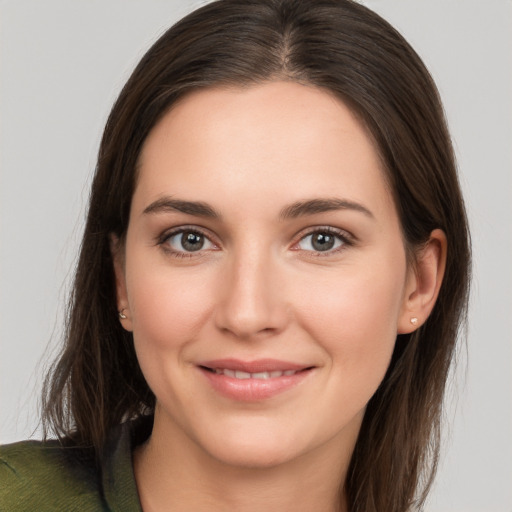 Joyful white young-adult female with long  brown hair and brown eyes