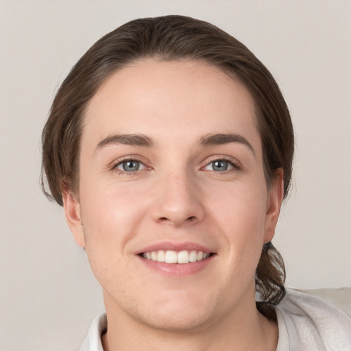 Joyful white young-adult female with short  brown hair and grey eyes