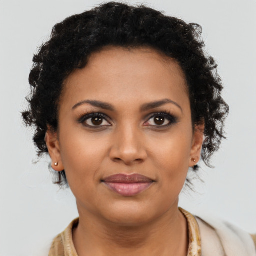 Joyful black young-adult female with short  brown hair and brown eyes