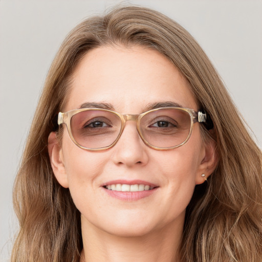 Joyful white young-adult female with long  brown hair and blue eyes