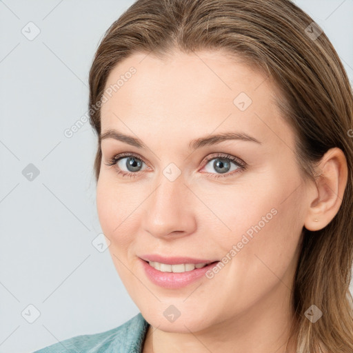 Joyful white young-adult female with medium  brown hair and blue eyes