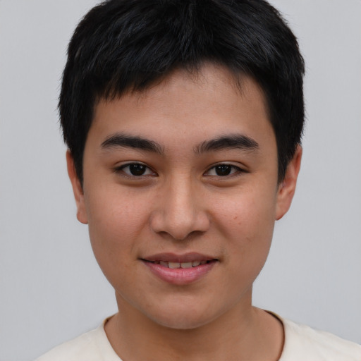 Joyful asian young-adult male with short  black hair and brown eyes