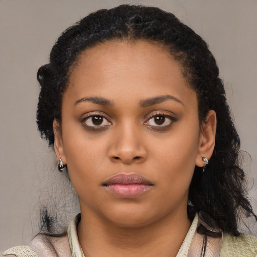 Neutral black young-adult female with long  brown hair and brown eyes