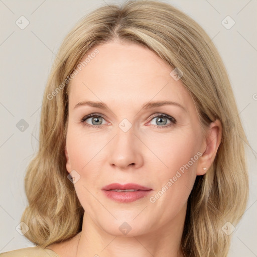 Joyful white adult female with medium  brown hair and blue eyes