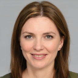 Joyful white young-adult female with medium  brown hair and green eyes