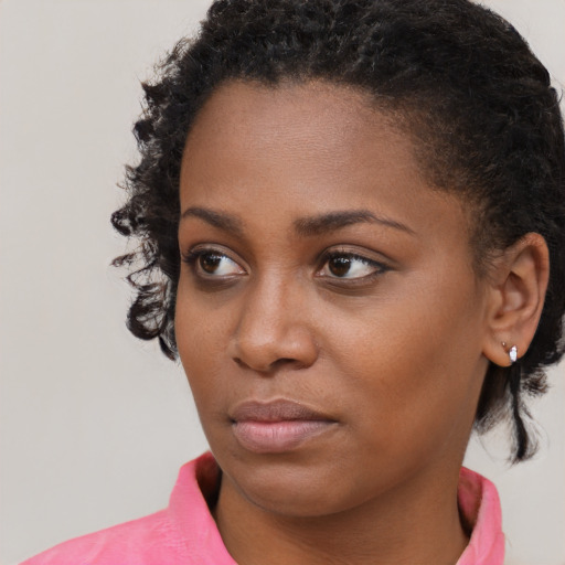 Neutral black young-adult female with medium  brown hair and brown eyes