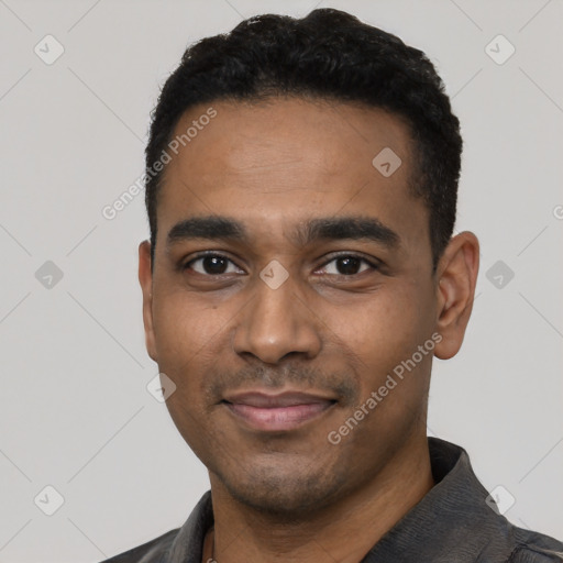 Joyful black young-adult male with short  black hair and brown eyes