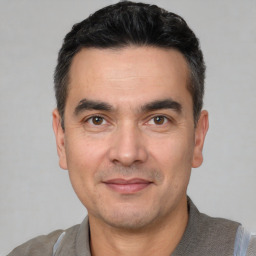 Joyful white adult male with short  black hair and brown eyes