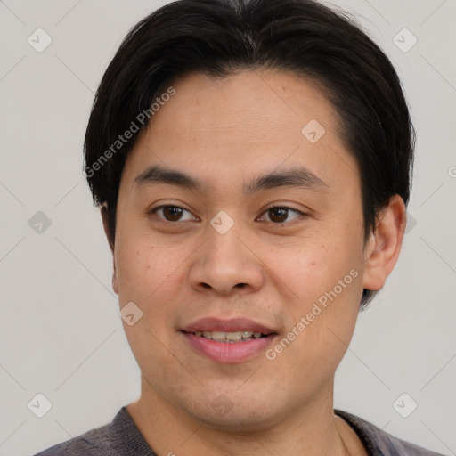 Joyful asian young-adult male with short  brown hair and brown eyes