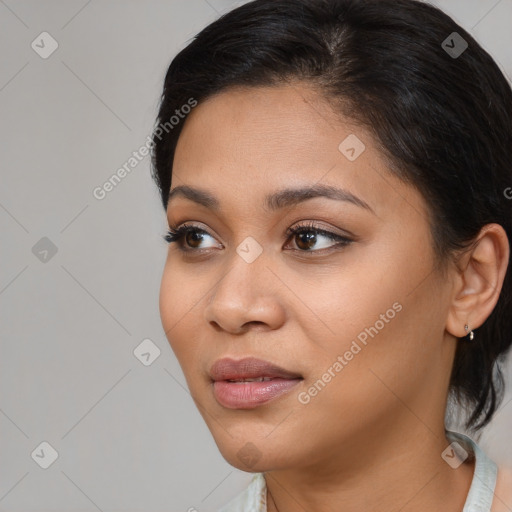 Joyful black young-adult female with medium  brown hair and brown eyes