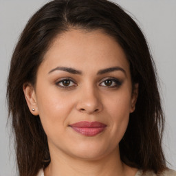 Joyful white young-adult female with long  brown hair and brown eyes