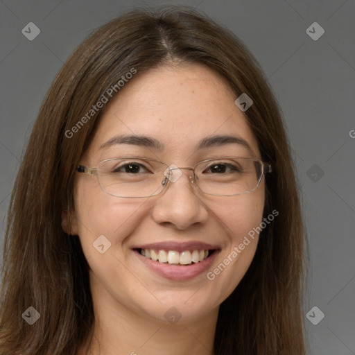 Joyful white adult female with long  brown hair and brown eyes