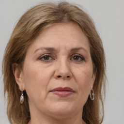 Joyful white adult female with medium  brown hair and grey eyes