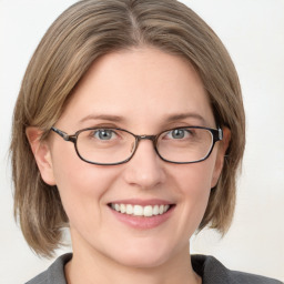 Joyful white adult female with medium  brown hair and blue eyes