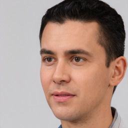 Joyful white young-adult male with short  black hair and brown eyes
