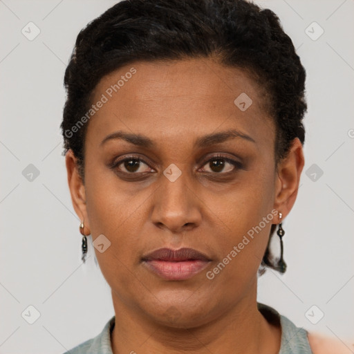 Joyful latino adult female with short  brown hair and brown eyes