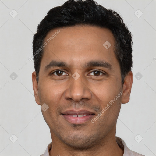 Joyful latino young-adult male with short  black hair and brown eyes