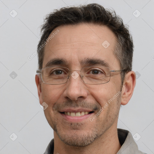 Joyful white adult male with short  brown hair and brown eyes