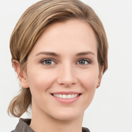 Joyful white young-adult female with short  brown hair and grey eyes