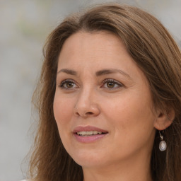 Joyful white adult female with long  brown hair and brown eyes