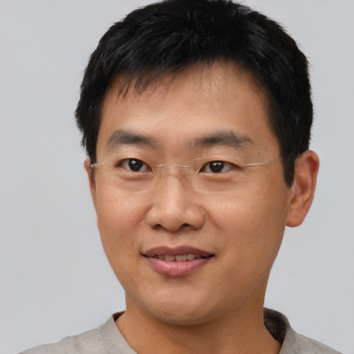 Joyful asian young-adult male with short  black hair and brown eyes