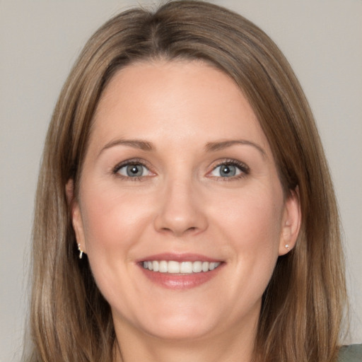 Joyful white adult female with medium  brown hair and brown eyes