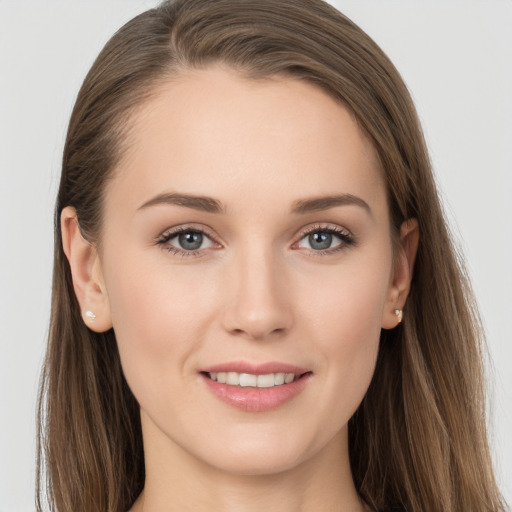 Joyful white young-adult female with long  brown hair and grey eyes