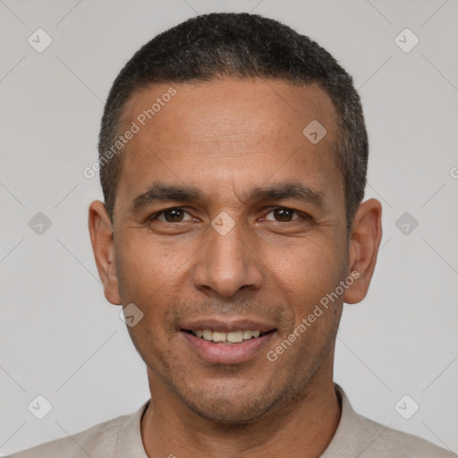 Joyful latino adult male with short  black hair and brown eyes