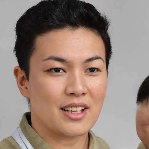 Joyful asian young-adult female with short  brown hair and brown eyes