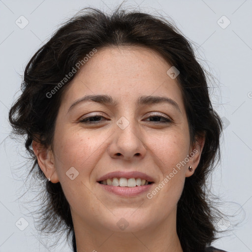 Joyful white adult female with medium  brown hair and brown eyes