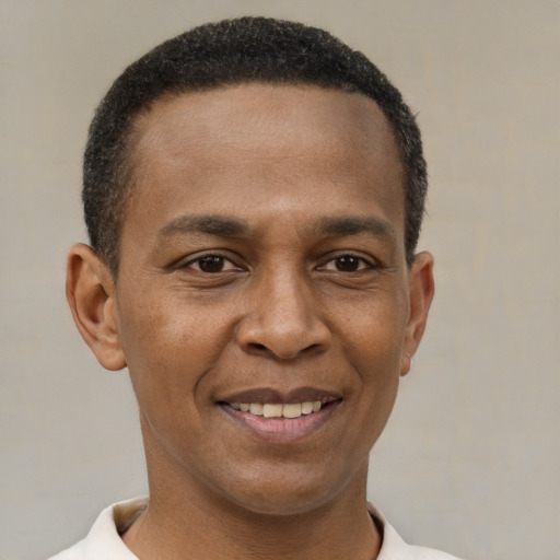 Joyful latino young-adult male with short  brown hair and brown eyes