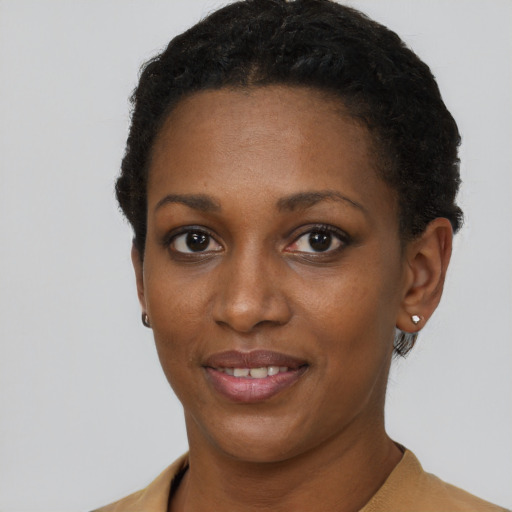 Joyful black young-adult female with short  brown hair and brown eyes