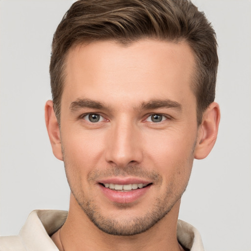 Joyful white young-adult male with short  brown hair and brown eyes