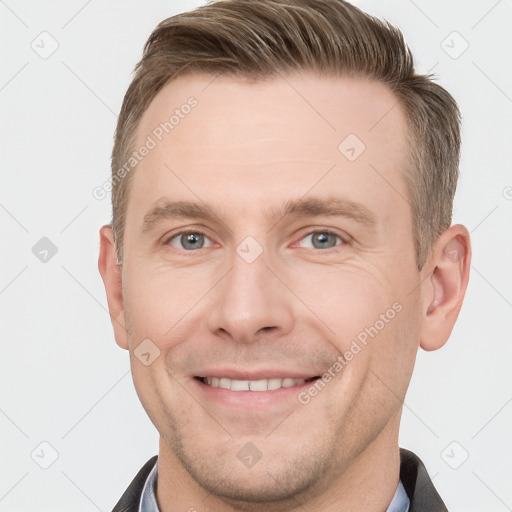 Joyful white adult male with short  brown hair and grey eyes