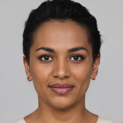 Joyful latino young-adult female with short  black hair and brown eyes