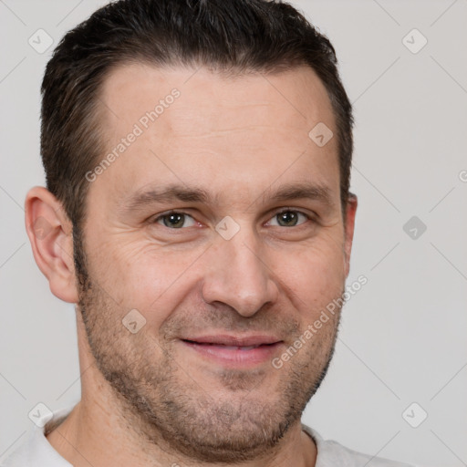 Joyful white adult male with short  brown hair and brown eyes