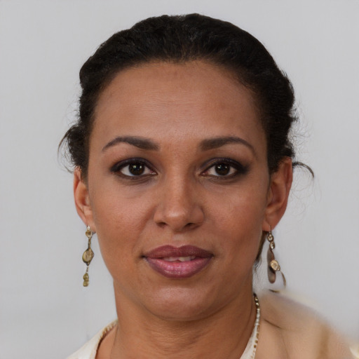 Joyful latino adult female with short  brown hair and brown eyes