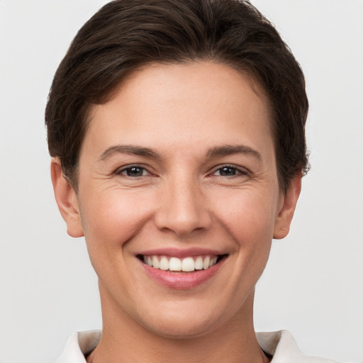 Joyful white young-adult female with short  brown hair and brown eyes