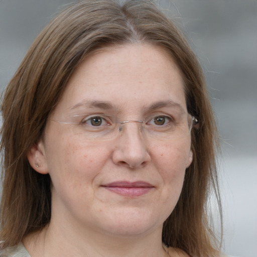 Joyful white adult female with medium  brown hair and grey eyes