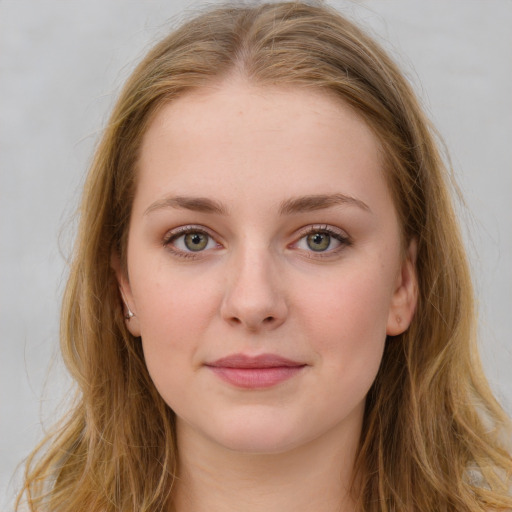 Joyful white young-adult female with long  brown hair and green eyes