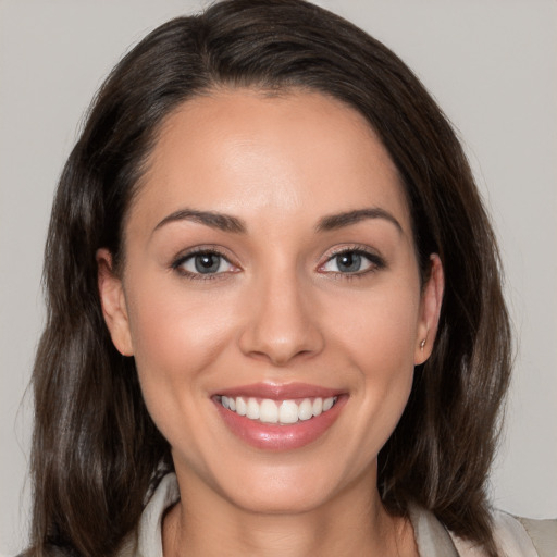 Joyful white young-adult female with medium  brown hair and brown eyes