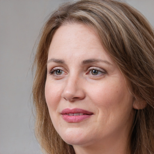 Joyful white adult female with long  brown hair and brown eyes