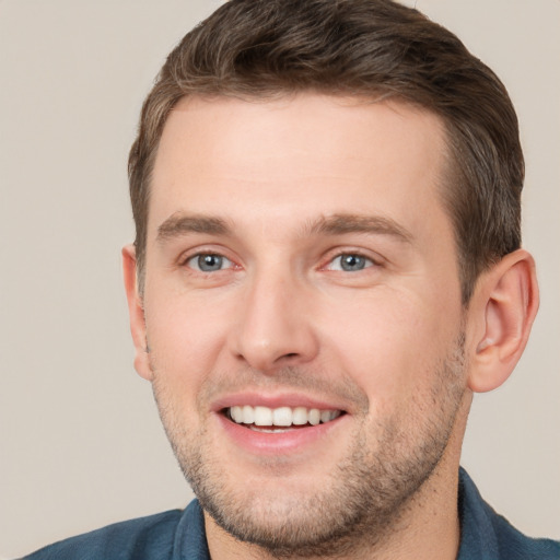 Joyful white young-adult male with short  brown hair and brown eyes