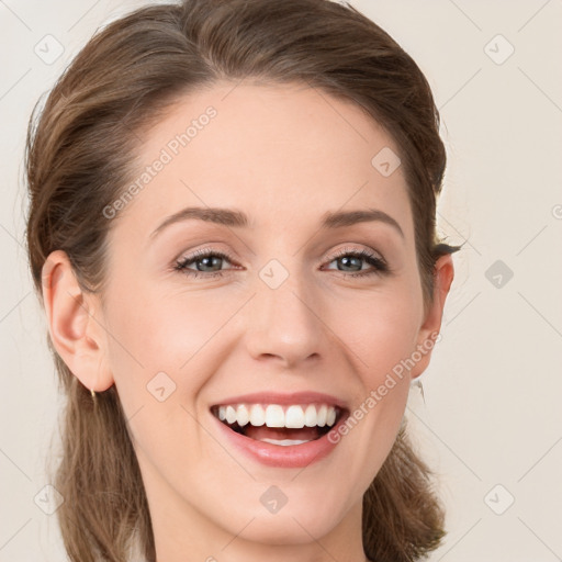 Joyful white young-adult female with long  brown hair and blue eyes