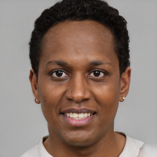 Joyful black young-adult male with short  black hair and brown eyes