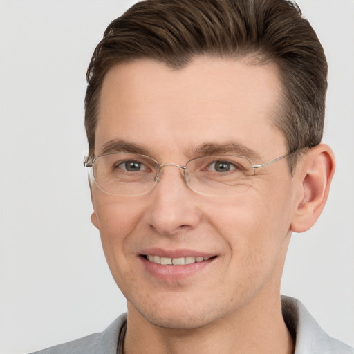 Joyful white adult male with short  brown hair and grey eyes