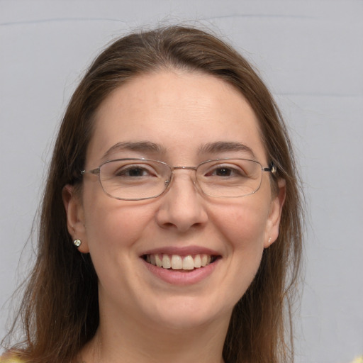 Joyful white adult female with long  brown hair and brown eyes