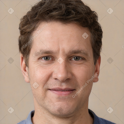 Joyful white adult male with short  brown hair and grey eyes