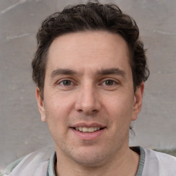 Joyful white adult male with short  brown hair and grey eyes