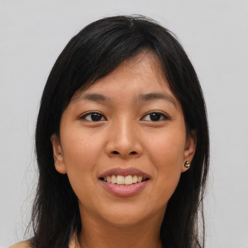 Joyful asian young-adult female with long  brown hair and brown eyes